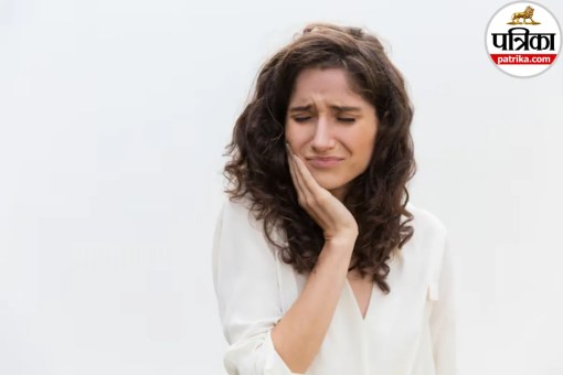Close-up shot of a person touching their jaw near the ear while experiencing jaw joint discomfort or TMJ popping sound