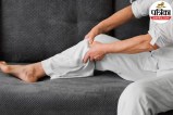 person experiencing severe night leg cramps calf muscle pain in bed